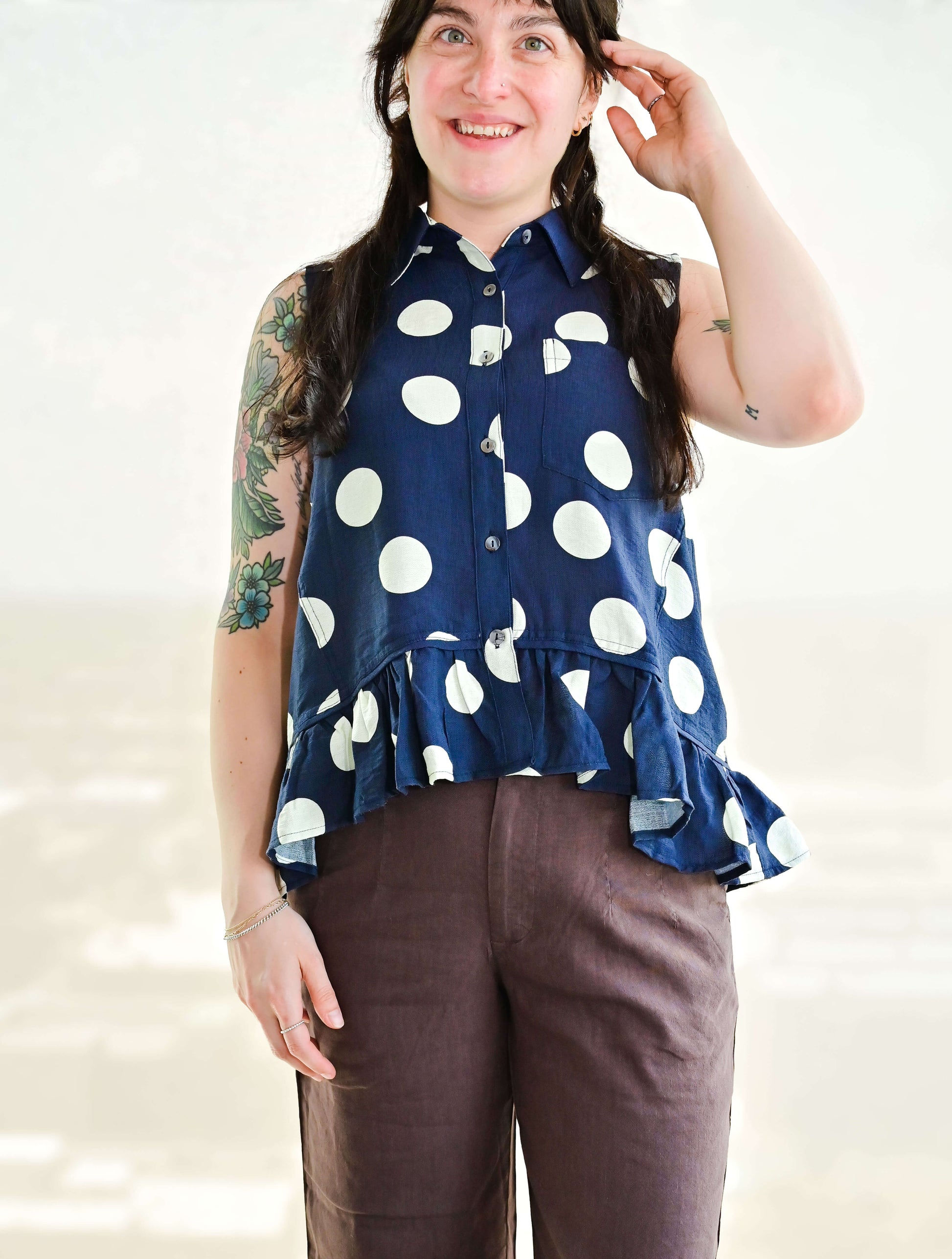 Polka Dot Sleeveless Button Up Blouse With Ruffle Hem